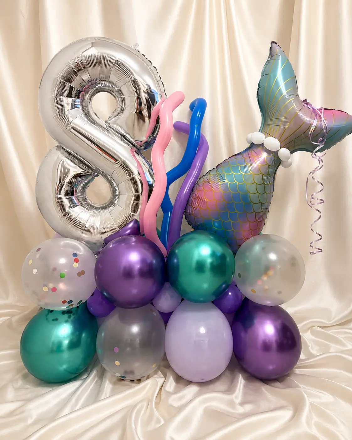 Colourful personalised mermaid balloon stack with an age balloon