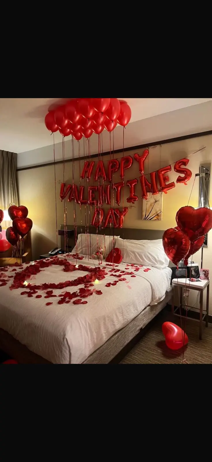 Romantic red balloon hotel room surprise setup